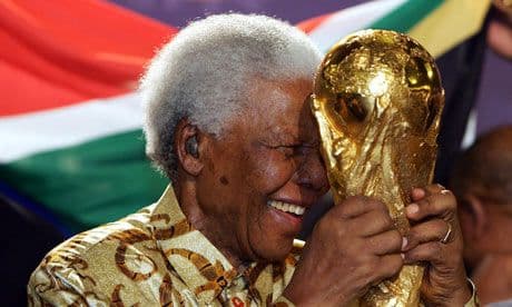 Former South Africa president Nelson Mandela holds the world cup trophy ahead of the tournament that was held in south Africa on 2010.